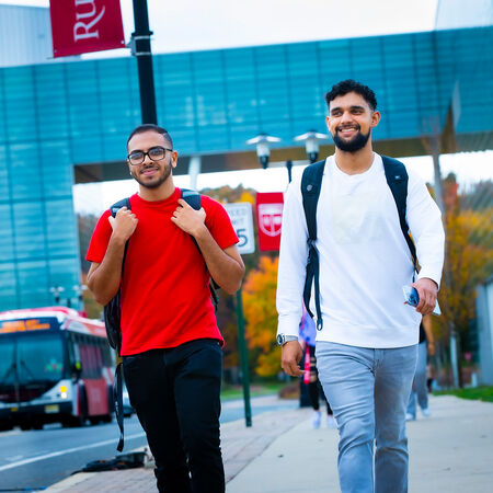 Students walking down sidewalk on Livingston campus